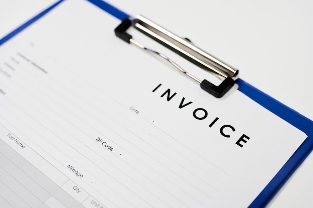 Physical invoice form on clipboard
